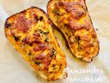 A picture of Butternut squash baked with chicken, vegetables and cheese.