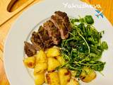 A picture of Pesto, Crusted Lamb Steak and Roast Potatoes with broccoli salad.