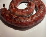 A picture of step 5 of Boerewors with mashed potatoes served with a tomato chili relish.